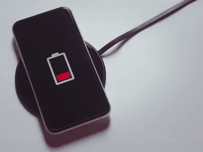 Smartphone with low battery connected to a charger
