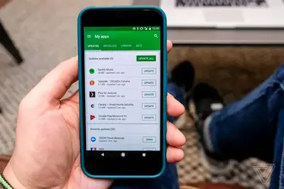 Hand holding a phone showing the app update screen